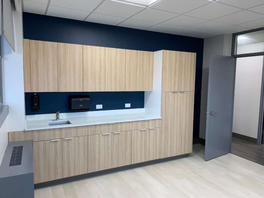 Renovated kitchen in a commercial space with wood cabinets and quartz countertops
